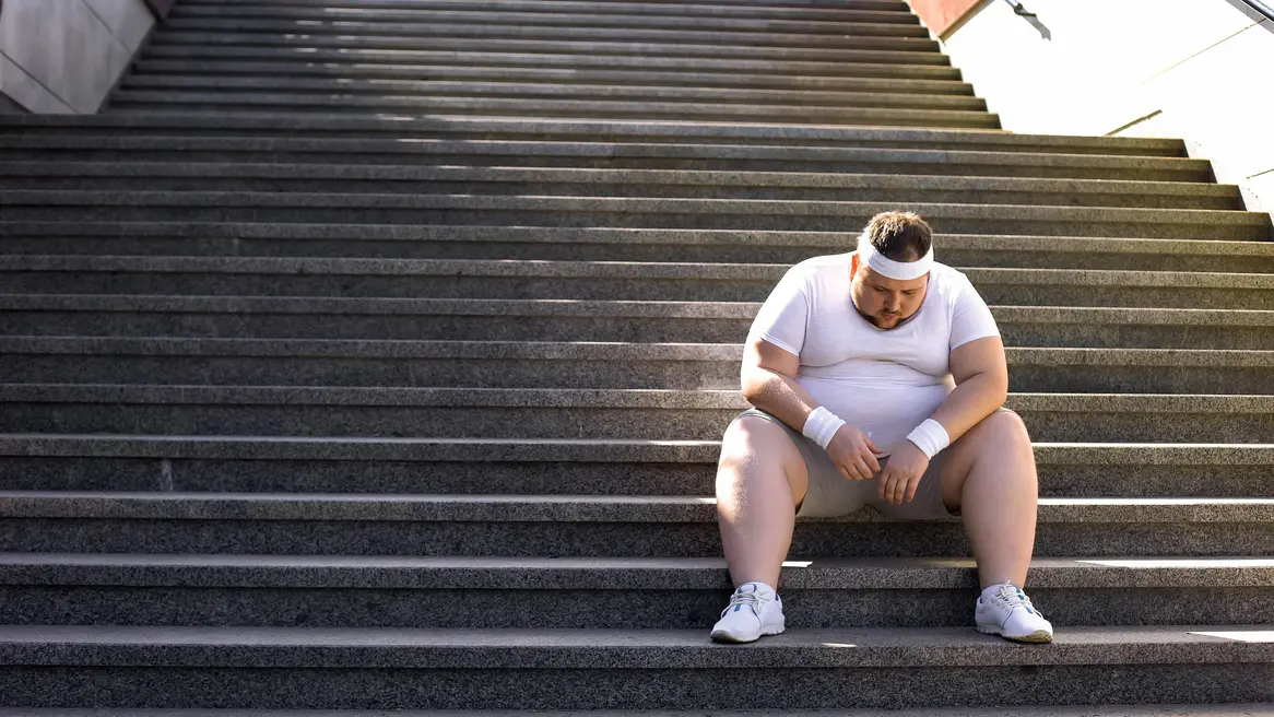 Dickerer Mann auf Treppe